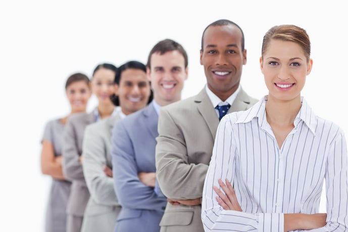 Close-up of smiling people dressed in suits crossing their arms in a single line with focus on the first woman