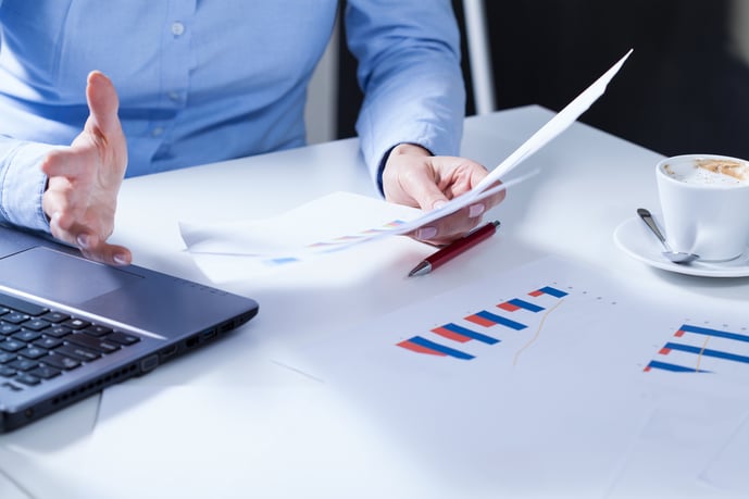 Close-up of young businesswoman holding survey results