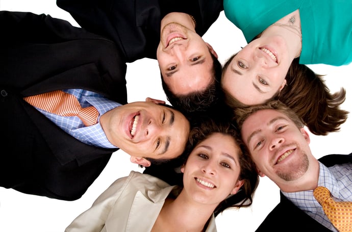 business team work - heads together over a white background